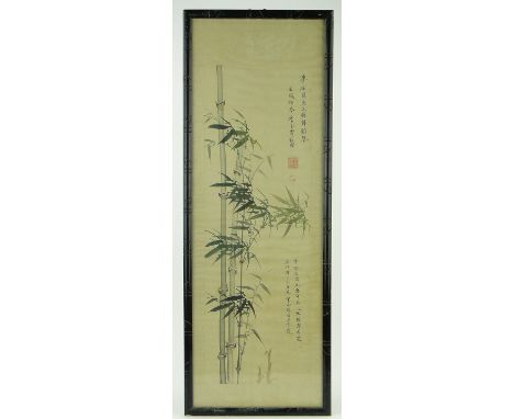 A Chinese scroll painting,
circa 1900-1920, bamboo trees with text, in carved stained wood frame, overall 45" x 16".