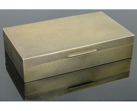 A 9ct gold engine turned cigarette box,
by Goldsmith's & Silversmith's Co., London 1929, width 15cm, wood lined, gross weight