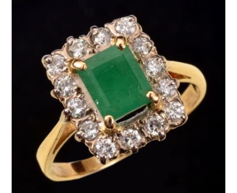 An Emerald and Diamond Cluster Ring corner claw-set step-cut emerald within a frame of fourteen pavé-set brilliant-cut diamon