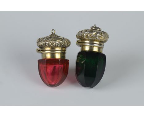 Two Vinaigrettes in ruby and green faceted glass having floral and leafage scroll engraved lids