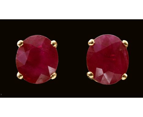 A pair of Ruby Ear Studs each claw-set oval-cut stone, total ruby weight 2.52cts, in 18ct gold