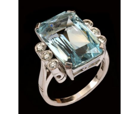 An Aquamarine and Diamond Ring corner claw-set step-cut aquamarine approx 11cts, between trios of millegrain-set brilliant-cu