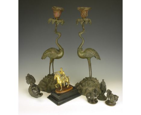 A group of Bronzes, comprising a pair of patinated crane candlesticks after models by Thomas Abbott, 15in. high; a Roman oil 