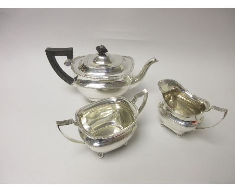 A George V silver three piece Tea Service of oblong form on ball feet, Chester 1913