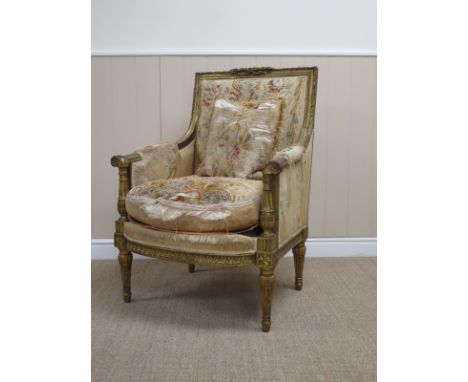 An antique French gilt Salon Armchair with oak leaf and ribbon carved surmount and frame surrounding Bouson region tapestry o