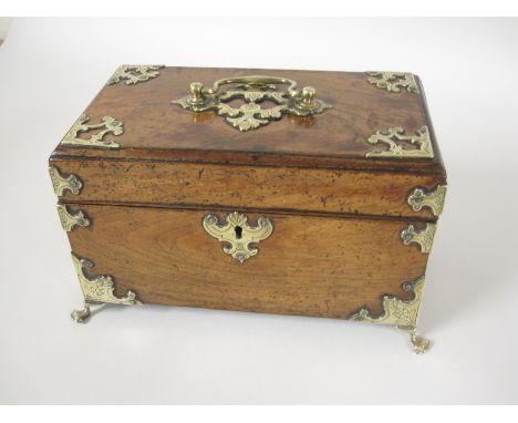 An 18th Century brass bound padouk Tea Caddy with interior divisions, finely engraved mounts, escutcheon, handle, on paw feet