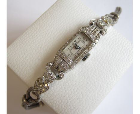 A 1920's Diamond Cocktail Watch the rectangular dial with arabic numerals, bezel and lugs millegrain-set eight-cut diamonds i