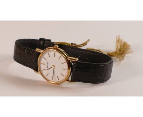 Seiko 9ct gold ladies wristwatch with black leather strap, in original Seiko wood box.