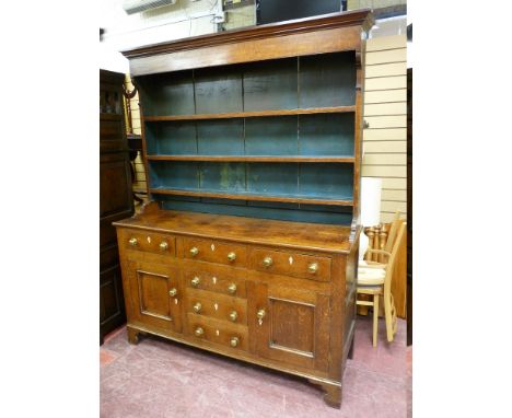 AN EARLY TO MID 19th CENTURY OAK NORTH WALES DRESSER having a three shelf rack over a base having three top drawers with cent