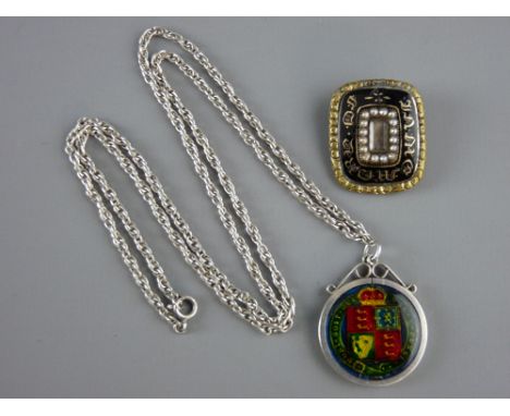 AN EARLY VICTORIAN MOURNING BROOCH and an enamelled 1887 shilling in a pendant mount with sterling silver chain, the mourning