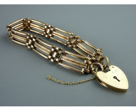 A NINE CARAT GOLD FOUR BAR BRACELET with safety chain and padlock, 15 grms
