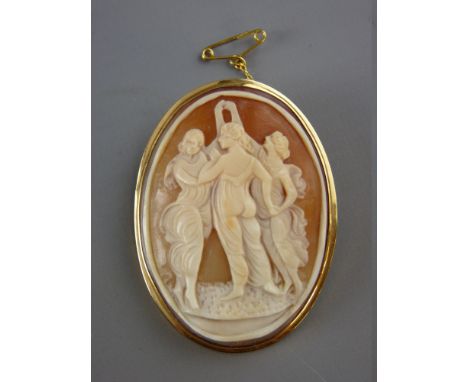 AN EIGHTEEN CARAT GOLD FRAMED CAMEO BROOCH depicting three standing classical ladies, with safety chain