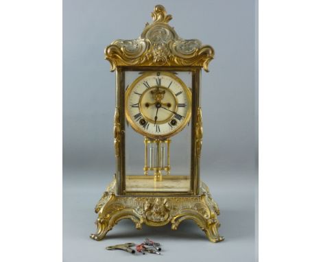 A 19th CENTURY FOUR PANE GILT BRASS MANTEL CLOCK, the dial with visible escapement set with Roman numerals before a brass mov