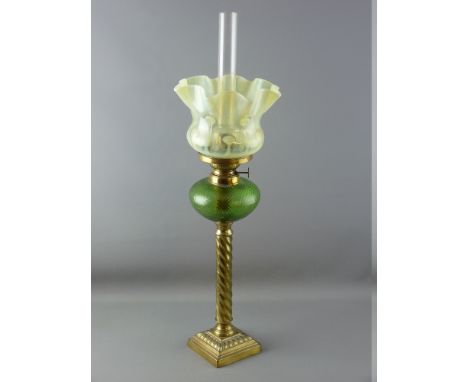 A VICTORIAN OIL LAMP with brass twist column, green glass reservoir and vaseline glass shade