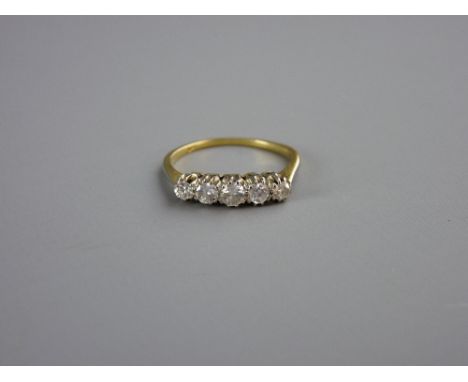 AN UNMARKED GOLD DRESS RING with five small diamonds, visual estimate 1.4 carats, 2.5 grms, size 'N'