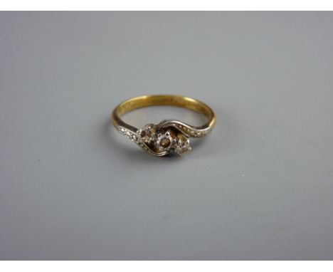 AN EIGHTEEN CARAT GOLD THREE STONE DIAMOND CROSSOVER RING, visual estimate of diamonds 0.2 carat each, size 'O', 3.3 grms gro