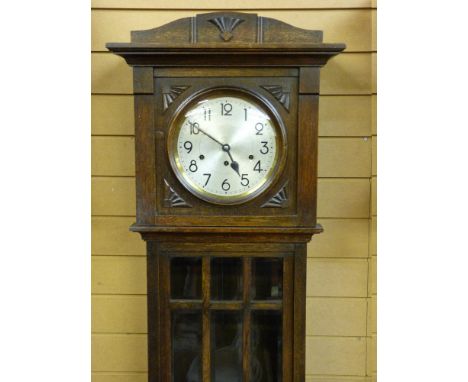 A 20th CENTURY OAK CHIMING LONGCASE CLOCK, the silvered dial set with Arabic numerals, the long trunk door with bevelled glas