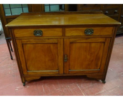 A COMPACT MAHOGANY SIDEBOARD having a railback with two drawers and two cupboards and on corner castors, 107 cms wide