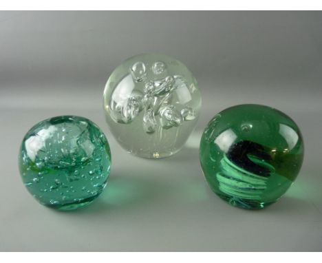 TWO VICTORIAN GREEN GLASS PAPERWEIGHTS & one other, one formed as an inkwell with bubble inclusion, a large later paperweight