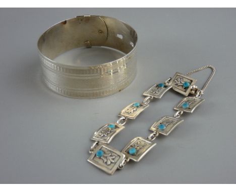 A WIDE SILVER BELT SHAPED BANGLE and a bracelet of floral panels, each set with a turquoise bead, marked Sterling Silver and 