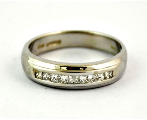 A 14ct white gold ring channel set with 9 princess cut diamonds (R.5).
