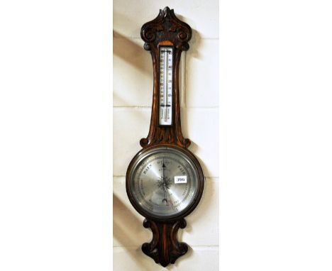 A 1920s carved oak barometer and thermometer, H. 83cm.