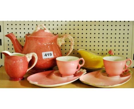 A Royal Winton teapot, milk jug, two biscuit cups and saucers and a small sauce boat.