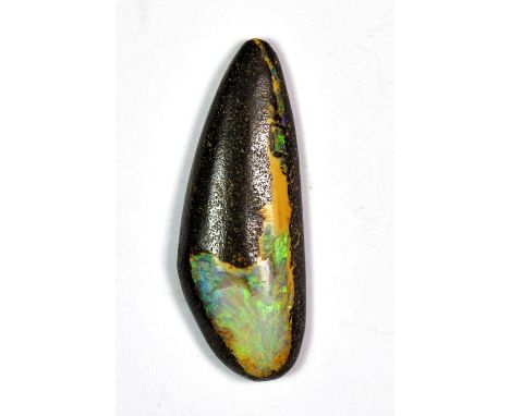 A large Australian boulder opal with flashes of green and blue. L 4cm.