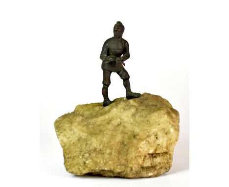 A small portrait figure of "Scott of the Antarctic" standing on a rock crystal base, H. 10.5cm.