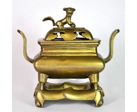 A 19th century Chinese bronze censor and stand, H. 17cm.