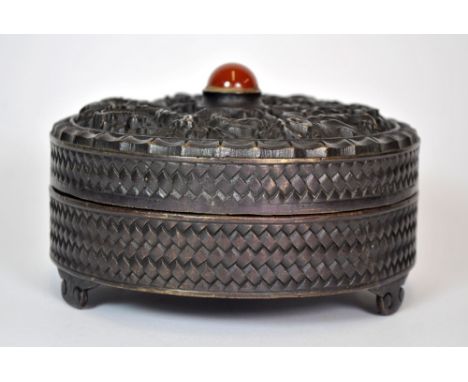 A Chinese cast bronze circular box and lid with cornelian decoration, Dia. 15cm.
