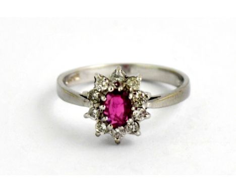 An 18ct white gold ruby and diamond cluster ring (O).