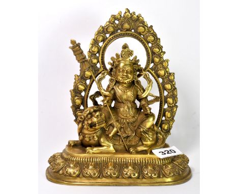 A Tibetan gilt bronze figure of a guardian Deity, H. 22cm.