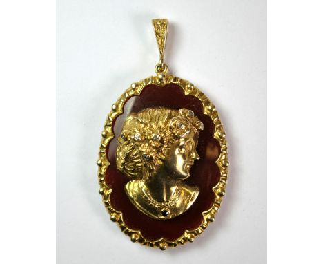 A 9ct gold hallmarked pendant set with a red cornelian and diamond set gold portrait cameo, H. 6.5cm, W. 3.7cm.