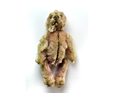 A rare miniature articulated Steiff teddy bear compact with removeable head, H. 8.5cm.