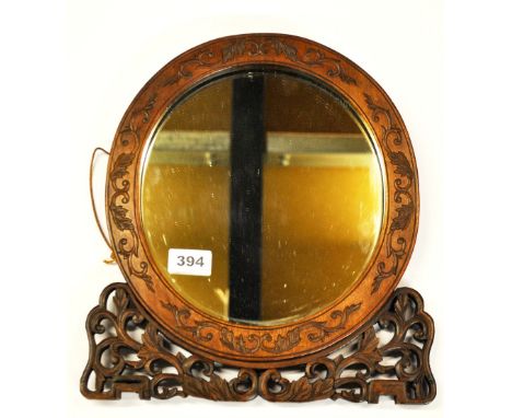 An oriental carved mirror, 31 x 33cm.