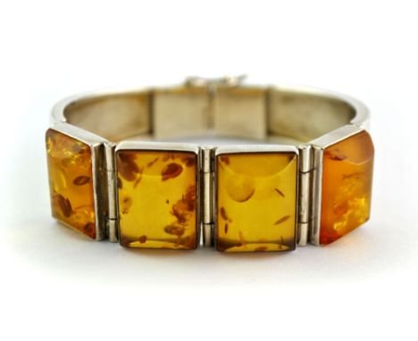 An interesting Art Deco style sterling silver and amber bangle.