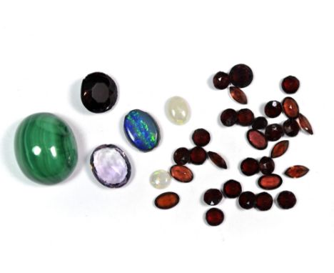 A cabochon cut malachite, an opal doublet, two further opals and other semi precious stones.