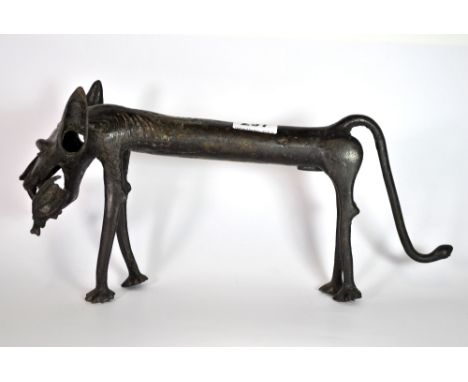 An early Benin bronze figure of a stylised lion with an animal in its mouth, L. 38cm.