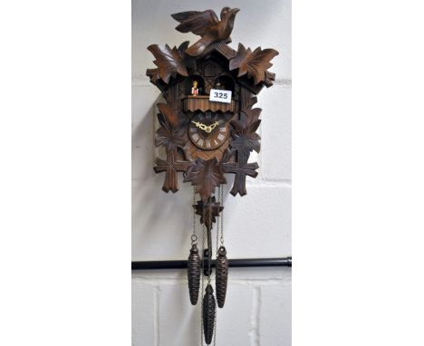 A Black Forest wooden cuckoo clock with a Swiss musical movement.