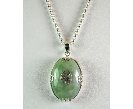 A Chinese silver and jade pendant.