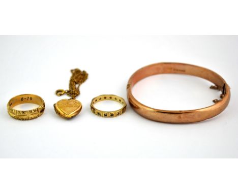 A 9ct gold bangle together with two 9ct gold rings and a back and front locket.