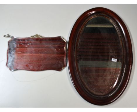 A 1920's oval mirror and an Art Deco mirror.