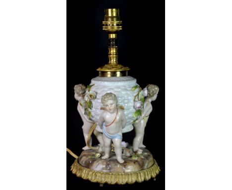 A lovely hand painted German porcelain cherub lamp base with gilt mounts, H. 27cm.