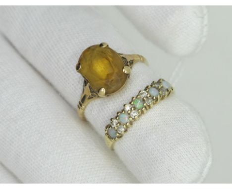 A 9ct Gold Opal Set Ring, (cracks) claw set throughout (finger size N); a single stone dress ring, four claw set, stamped "9c