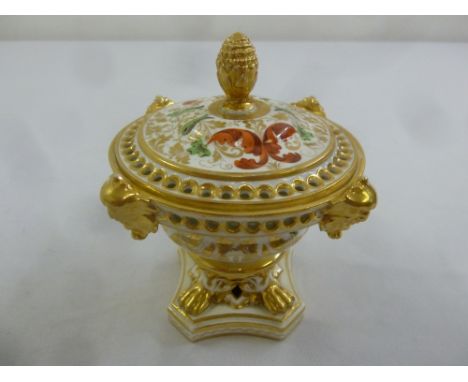 An early 19th century English porcelain potpourri bowl with pierced pull off cover and bud finial