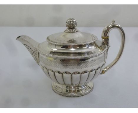 A George III silver coffee pot of circular lobed form the hinged cover with bud finial on raised circular base, London 1810 b