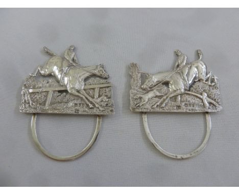 A pair of Victorian silver menu holders depicting hunting scenes and with hinged back struts, London 1895