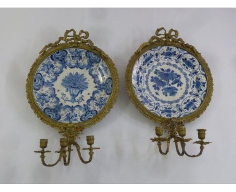 A pair of Continental 19th century ormolu, blue and white ceramic girandoles supporting three branch candle holders to the ba