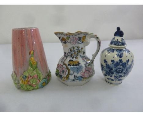 A Clarice Cliff trickle glaze and floral vase, a Masons iron stone milk jug and a Delft vase and cover